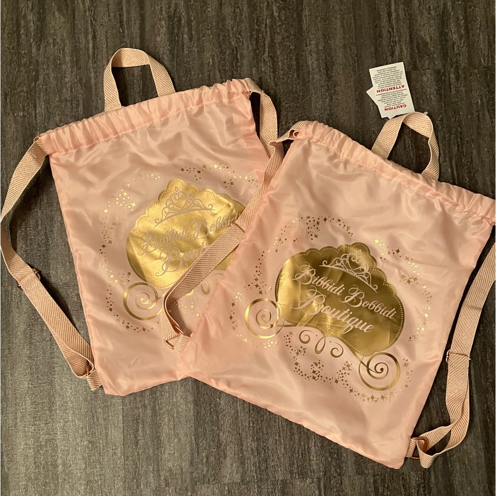 2 / $12 - 2-pack Bibbidi Bobbidi Boutique pink polyester drawstring backpack bag